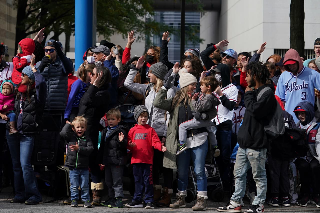 Baseball fans cheer ahead of a victory parade, Friday, Nov. 5, 2021, in Atlanta. The Braves beat the Houston Astros 7-0 in Game 6 on Tuesday to win their first World Series baseball title in 26 years. (AP Photo/Brynn Anderson)