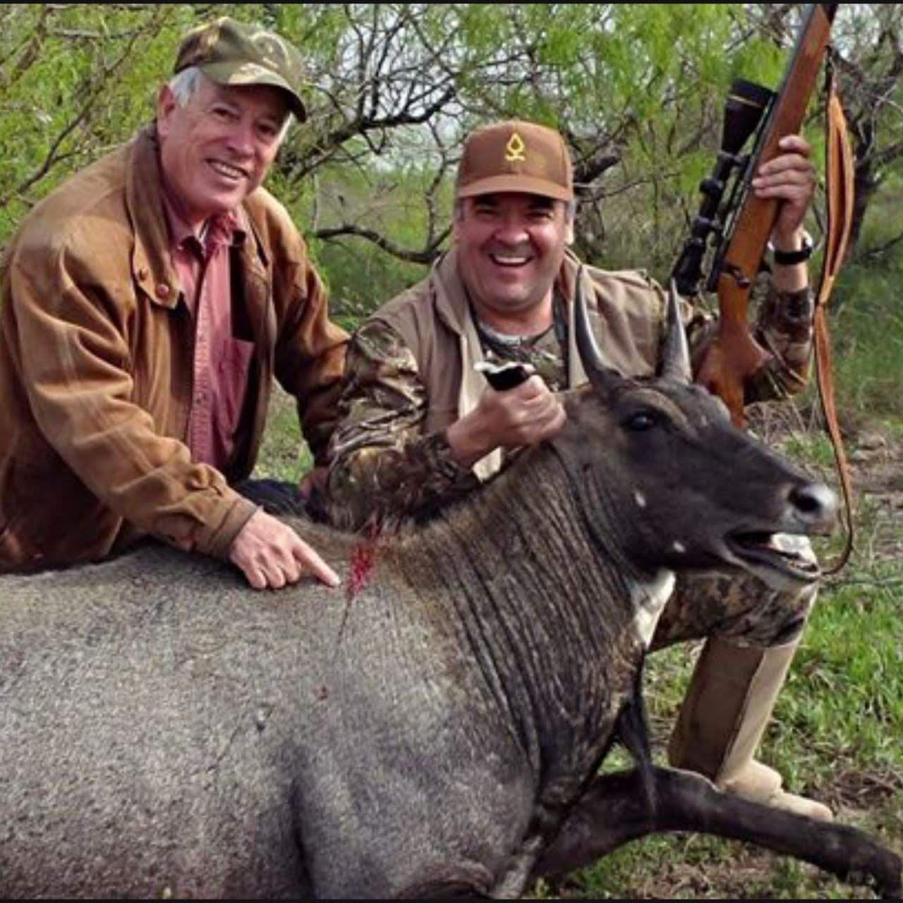 Cisneros and Jimenez on a hunting trip at the Kenedy Ranch in Texas. Seen here with a nilgai, the largest Asian antelope, after it was felled by Jimenez.