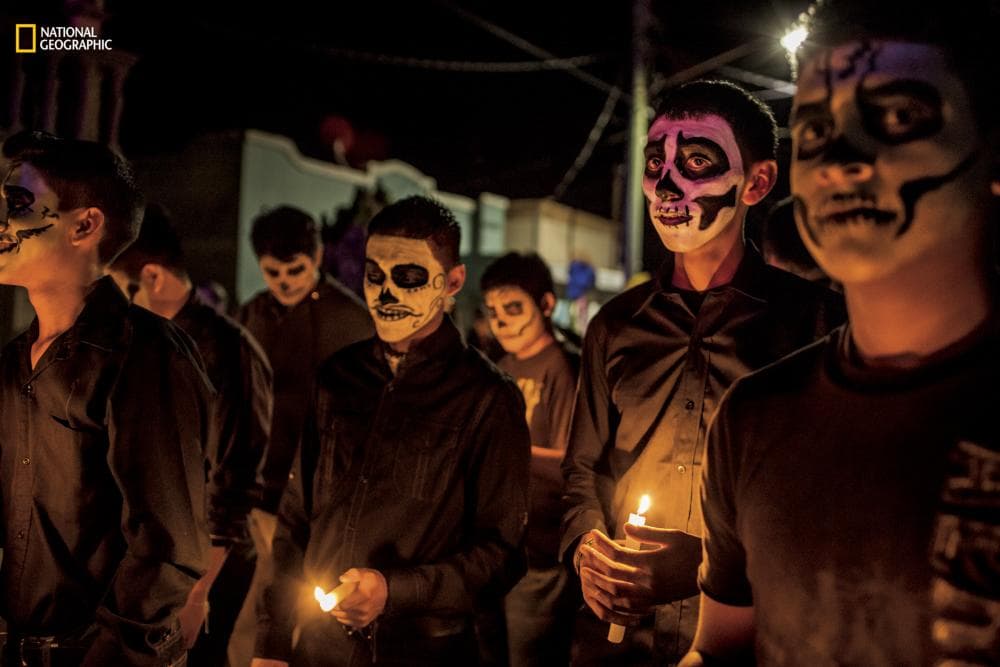 Residents of Allende, with faces painted with skulls, participate in the Day of the Dead celebrations.