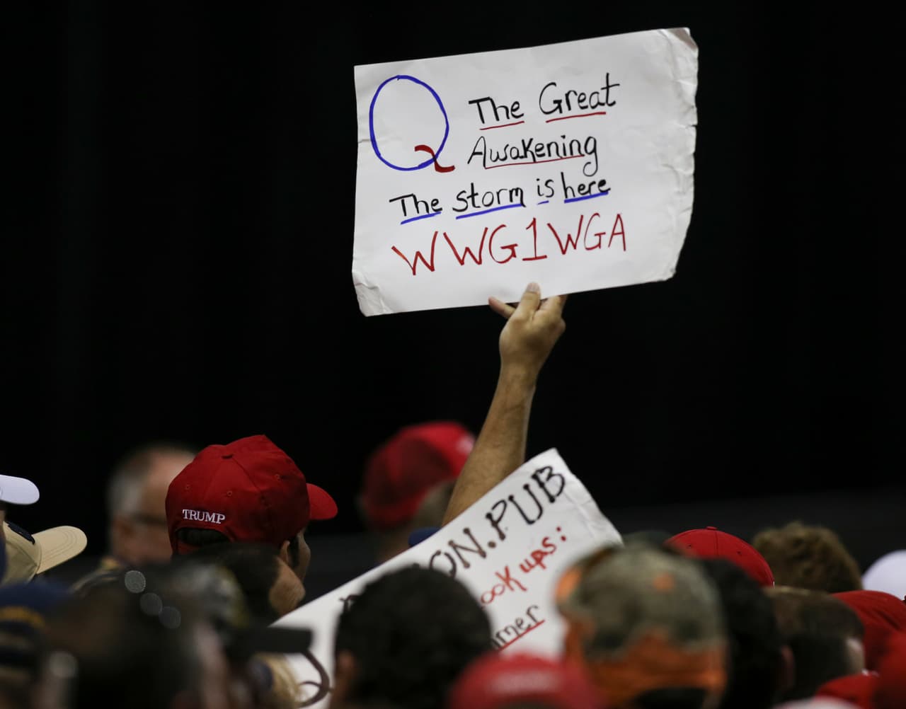 Trump supporters displaying QAnon posters appeared at President Donald J. Trumps Make America Great Again rally Tuesday, July 31, 2018 at the Florida State Fair Grounds in Tampa Florida. (Photo by Thomas O'Neill/NurPhoto via Getty Images)