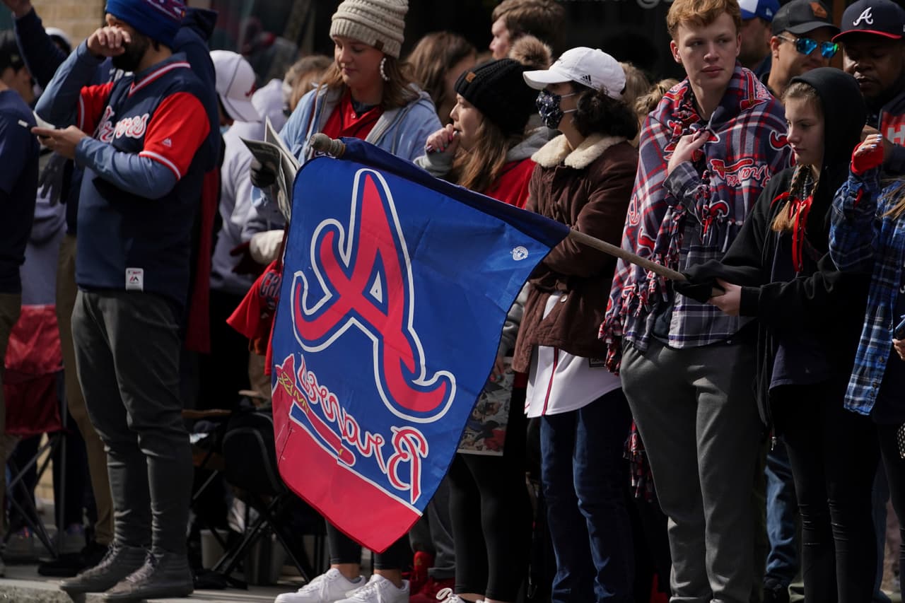 Baseball fans cheer ahead of a victory parade for the Atlanta Braves, Friday, Nov. 5, 2021, in Atlanta. The Braves beat the Houston Astros 7-0 in Game 6 on Tuesday to win their first World Series baseball title in 26 years. (AP Photo/Brynn Anderson)