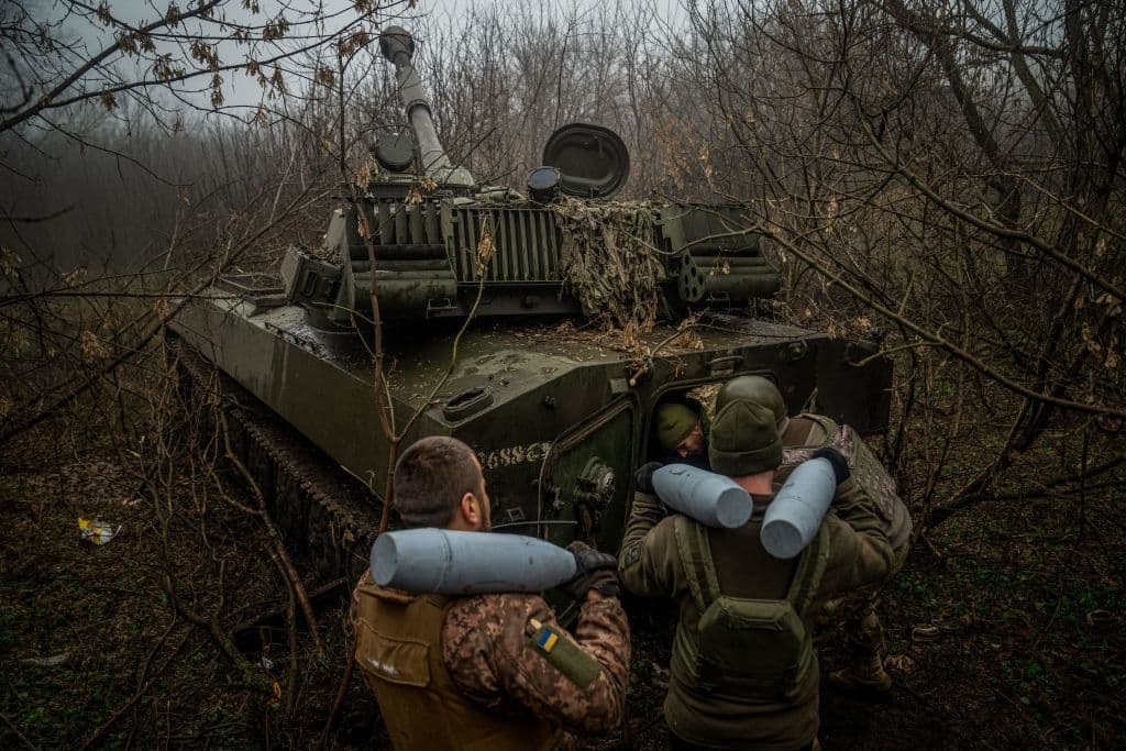 Ukrainian artillerymen load an ammunition inside of a 2S1 Gvozdika self-propelled howitzer at a position along the front line in the vicinity of Bakhmut, Donetsk region, on December 10, 2022.