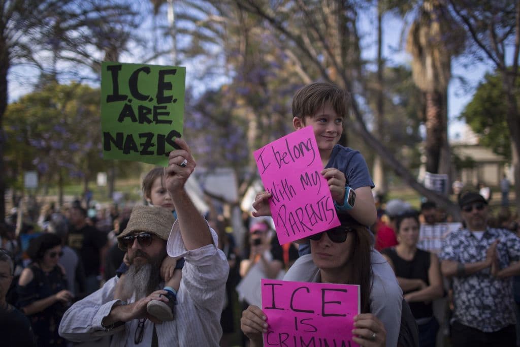 "Pertenezco a mis padres", dice el mensaje de este niño. Al lado, otra pancarta acusa de "nazis" al Servicio de Inmigración y Aduanas (ICE).