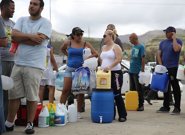 AIBONITO, PUERTO RICO - SEPTEMBER 24: People wait in line for water as they wait for gas, electrical and water grids to be repaired September 24, 2017 in Aibonito, Puerto Rico. Puerto Rico experienced widespread damage after Hurricane Maria, a category 4 hurricane, passed through. (Photo by Joe Raedle/Getty Images)