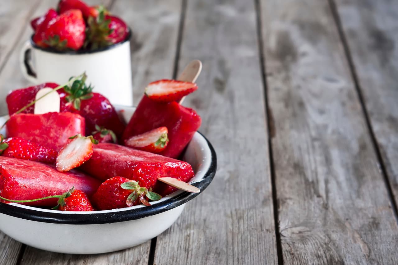 PALETA DE FRESAS EN OPORTO Ingredientes: 1 lb de fresas 4 oz de oporto 1 Cda de azúcar Preparación: corta las fresas en cubos pequeños. En un tazón mezcla la fruta con el azúcar y agrega el oporto hasta que las fresas queden cubiertas. Cubre con papel film y refrigera para que las fresas suelten agua y absorban el oporto. Déjalas reposar así en el refrigerador una noche. Al día siguiente licúa la mezcla y viértela en un molde para paletas. Congélalas y espolvoréalas con canela antes de servirlas.