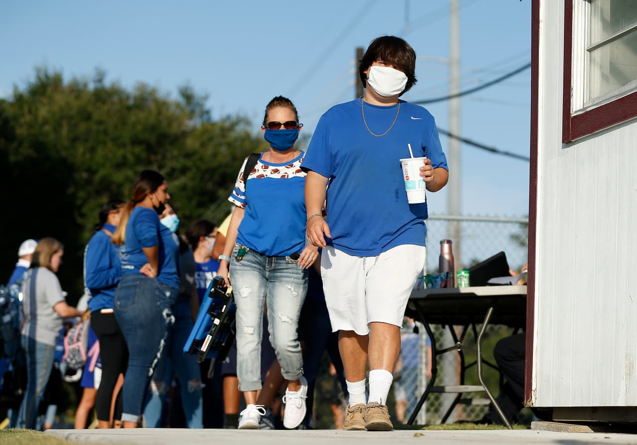 EAST BERNARD, TEXAS - AUGUST 28: Edna Cowboys fans wear masks while arriving to the stadium before the game against the East Bernard Brahmas on August 28, 2020 in East Bernard, Texas. (Photo by Tim Warner/Getty Images)