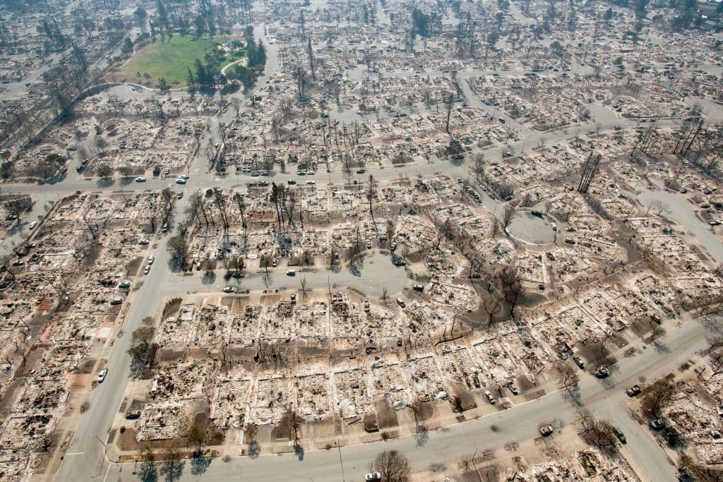 TOPSHOT - An aerial view shows burned properties in Santa Rosa, California on October 12, 2017. Hundreds of people are still missing in massive wildfires which have swept through California killing at least 26 people and damaging thousands of homes, businesses and other buildings. / AFP PHOTO / JOSH EDELSON (Photo credit should read JOSH EDELSON/AFP/Getty Images)
