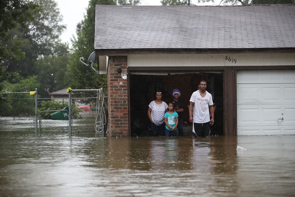 HOUSTON, TX - AUGUST 28: People wait to be rescued from their flooded homes after the area was inundated with flooding from Hurricane Harvey on August 28, 2017 in Houston, Texas. Harvey, which made landfall north of Corpus Christi late Friday evening, is expected to dump upwards to 40 inches of rain in Texas over the next couple of days. (Photo by Joe Raedle/Getty Images)