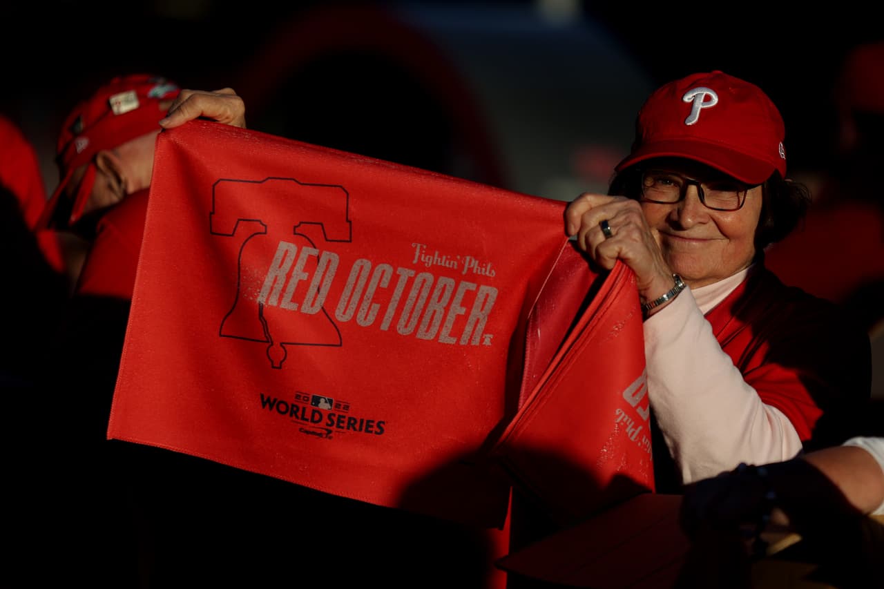Un ujier sostiene una bandera de "Octubre Rojo" antes del Juego Cinco de la Serie Mundial 2022 entre los Phillies de Filadelfia y los Astros de Houston.