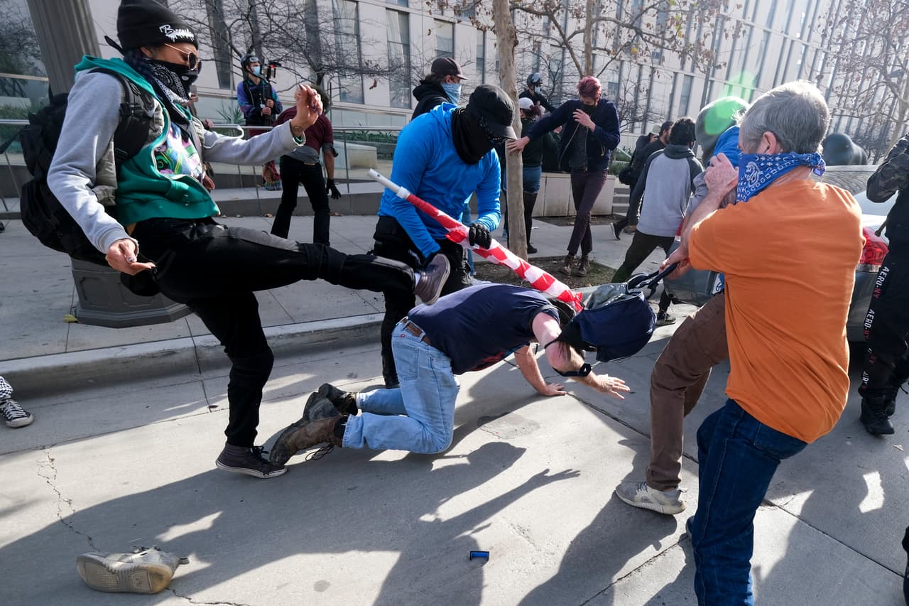 Con banderas y carteles que decían "Stop the Steal" (paren el robo), los miembros del grupo se pararon a lo largo de Spring Street mientras otros rodeaban el área en sus vehículos.