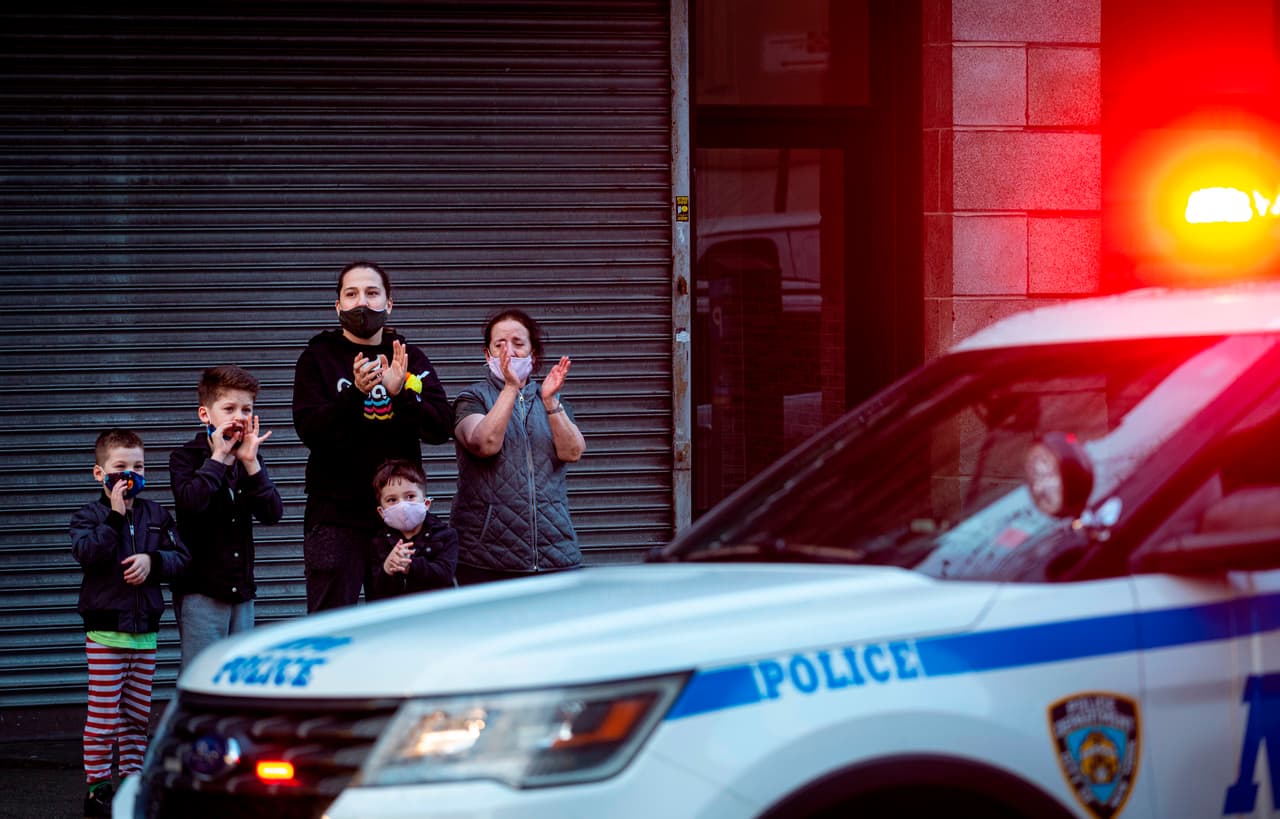 Una familia aplaude frente al hospital Mount Sinai en Queens, como agradecimiento a la policía, el personal de emergencia y los médicos. 13 de abril.