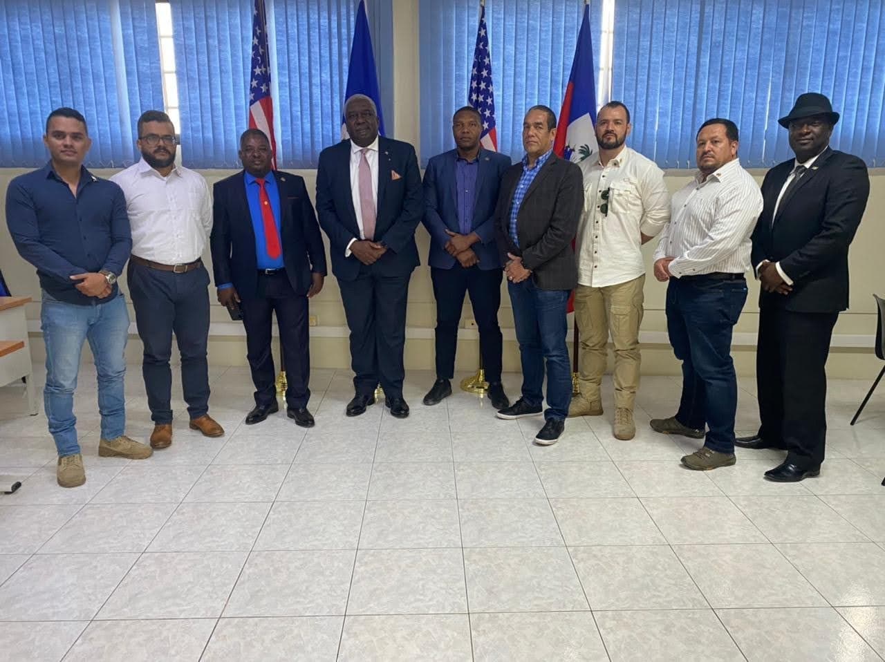 Pastor Christian Sanon standing in the centre (in suit and grey hair) with members of his Colombian security team and CTU Security president Antonio Intriago. From left to right: former Sergeant Javier Romero, Captain German Rivera, known as 'Colonel Mike', former Haitian Senator John Joel Joseph, Christian Sanon, the group's Haitian-American translator, James Solages, Antonio Intriago, another former Colombian soldier of unknown identity, former Sergeant Duberney Capador, and Ashkard Joseph Pierre, a purported Haitian diplomat.