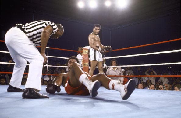Boxing: WBA/WBC Heavyweight Title: George Foreman tries to get off the canvas as referee Zack Clayton checks on him during the match against Muhammad Ali at 20th of May Stadium. Kinshasa, Zaire 10/30/1974 CREDIT: Tony Triolo (Photo by Tony Triolo /Sports Illustrated/Getty Images) (Set Number: X19073 )