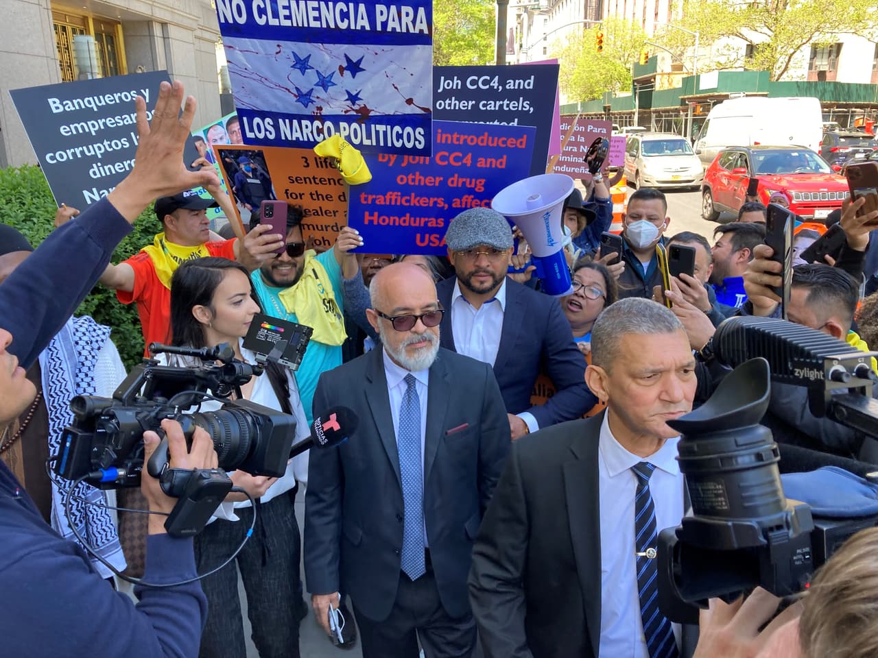 Private detective Angel Martinez leaving court hearing, May 10, 2022, surrounded by media and anti-Hernandez protesters.