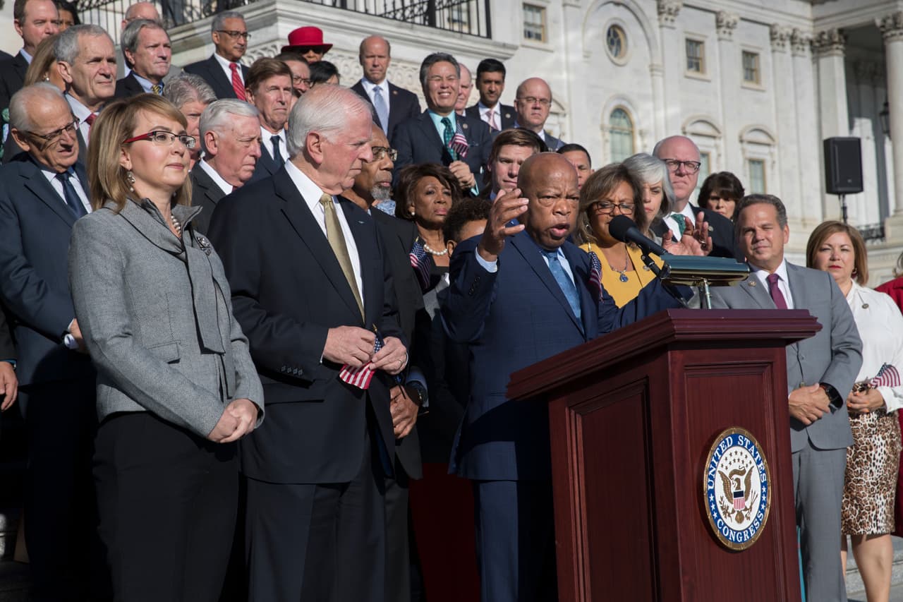 Civil rights leader Rep. John Lewis, D-Ga., speaking, joined by, from left, former Rep. Gabby Giffords of Arizona, and Rep. Mike Thompson, D-Calif., call for action on gun safety legislation with fellow Democrats on the House steps Wednesday morning after the deadly mass shooting in Las Vegas this week, at the Capitol in Washington, Wednesday, Oct. 4, 2017. Giffords survived an assassination attempt in 2011 while speaking to constituents in Tucson. (AP Photo/J. Scott Applewhite)