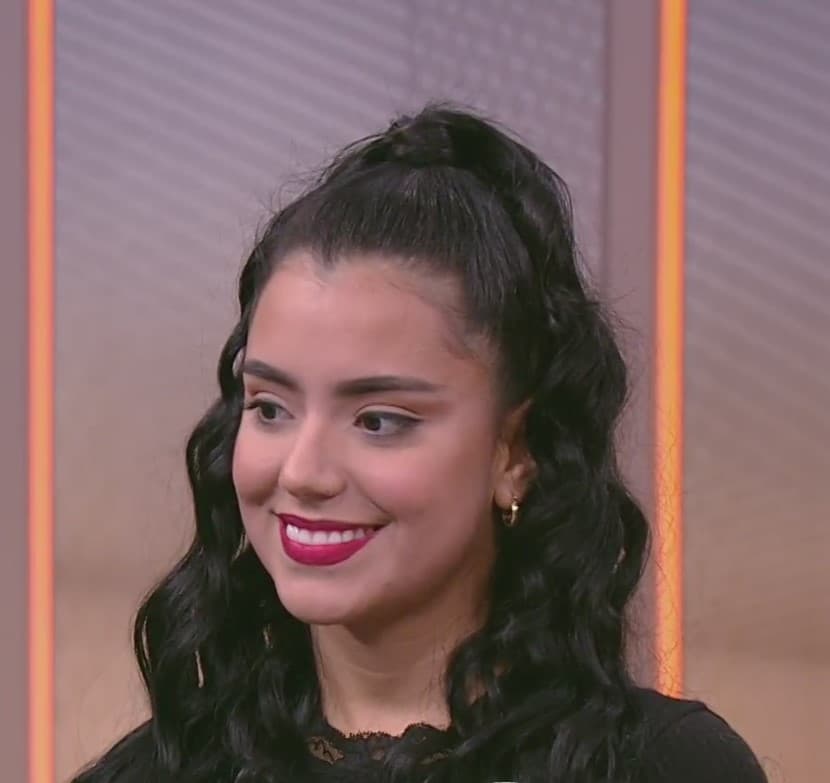 “En lugar de hacerlo con lápiz líquido, que a veces cuesta mucho, lo haremos con lápiz negro que sea bien cremoso. Vamos a pintar bien pegadito a las pestañas, no nos preocupemos tanto en que salga derechito, sino de depositar el producto. Luego con un pincel angular, de estos que vienen más larguitos en un lado y más cortitos en el otro, vamos a pasar por encima”, señaló Mariela, al seguir con las instrucciones para delinear el ojo como lo hacía Selena Quintanilla.
<br>