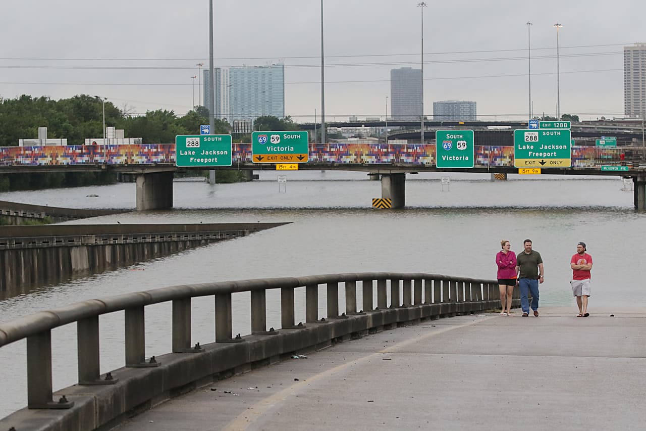 People view the flooded highways in Houston on August 27, 2017 as the city battles with tropical storm Harvey and resulting floods. Massive flooding unleashed by deadly monster storm Harvey left Houston -- the fourth-largest city in the United States -- increasingly isolated Sunday as its airports and highways shut down and residents fled homes waist-deep in water. / AFP PHOTO / Thomas B. Shea (Photo credit should read THOMAS B. SHEA/AFP/Getty Images)