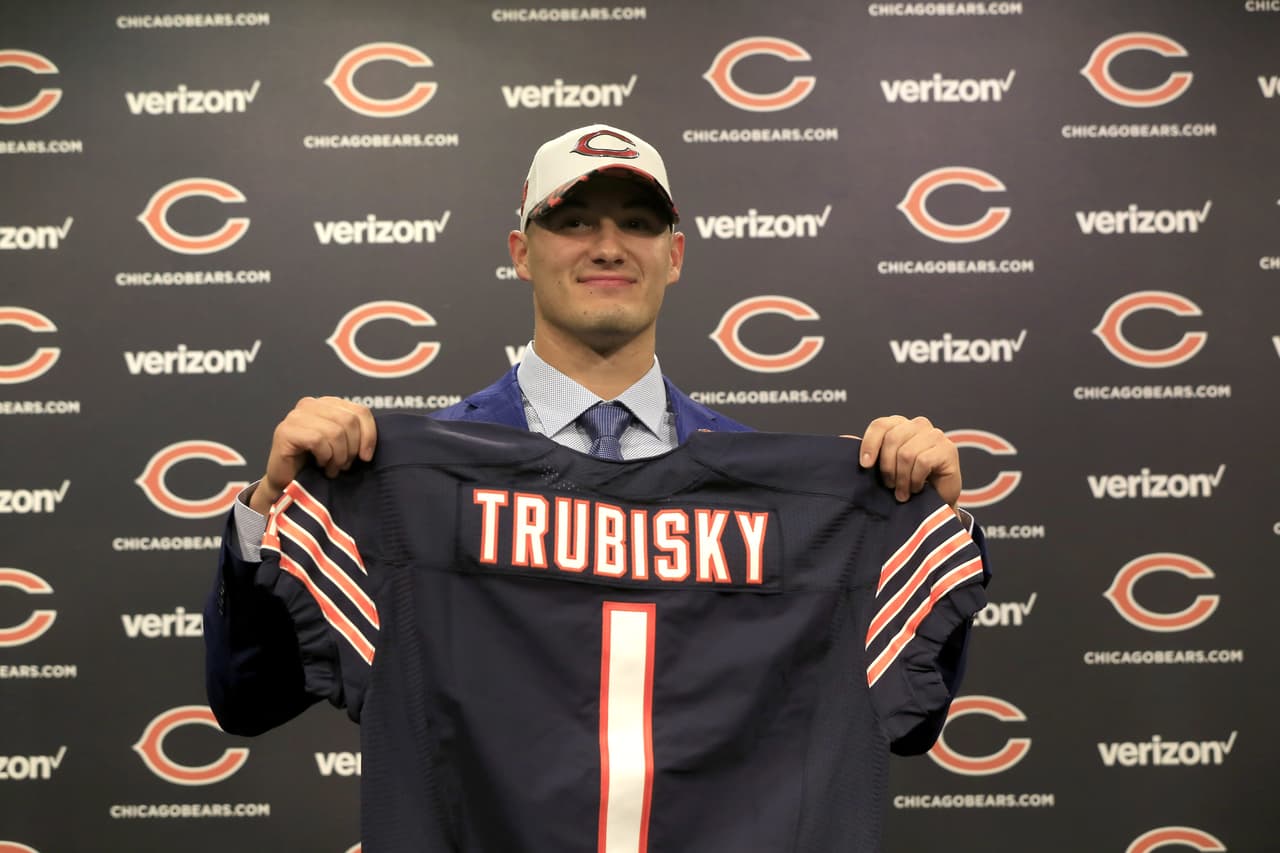 The Chicago Bears' first round draft pick quarterback Mitchell Trubisky, from North Carolina, poses with a Bears' jersey during an NFL football news conference Friday, April 28, 2017, in Lake Forest , Ill. (AP Photo/Charles Rex Arbogast)