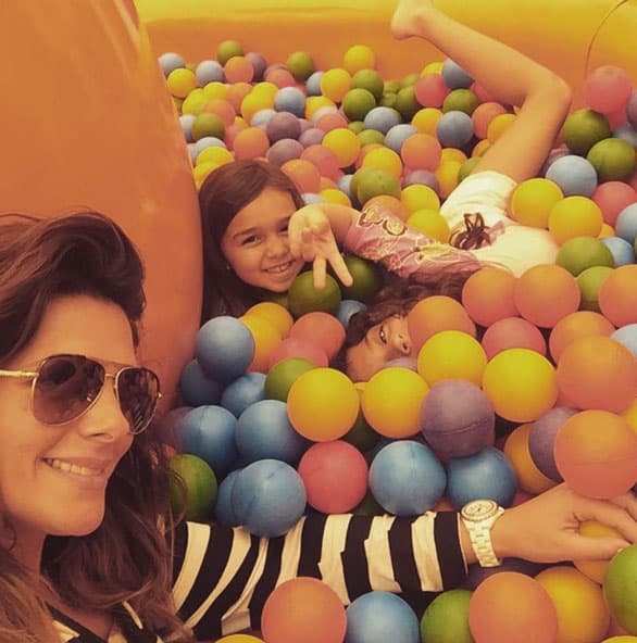 Divirtiéndose en la alberca de pelotas con sus pequeñas.