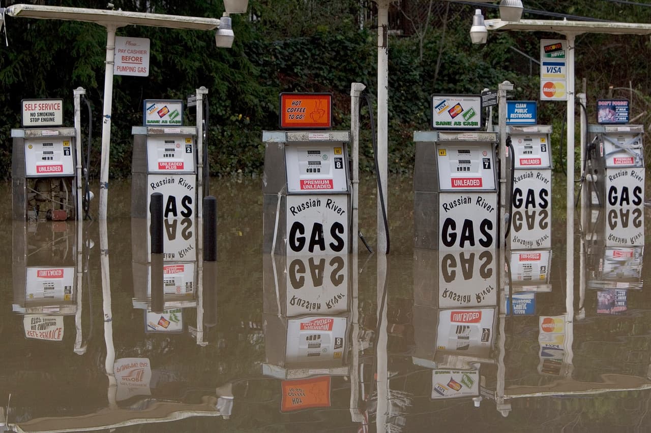 GUERNEVILLE, CA - JANUARY 2: A gas station on River Road sits partially under water on January 2, 2006 in Guerneville, California. Northern California has been inundated by heavy rain over the past week, causing mudslides and rivers to spill over their banks. (Photo by David Paul Morris/Getty Images)