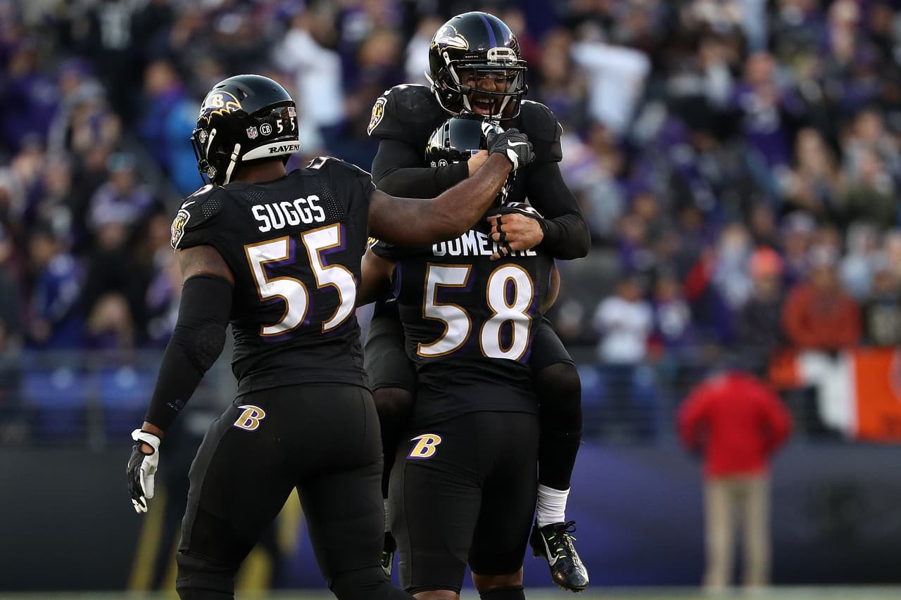 BALTIMORE, MD - NOVEMBER 27: Outside linebacker Elvis Dumervil #58 of the Baltimore Ravens reacts with teammates Strong safety Eric Weddle #32 and outside linebacker Terrell Suggs #55 after forcing a fumble against the Cincinnati Bengals in the fourth quarter at M&T Bank Stadium on November 27, 2016 in Baltimore, Maryland. (Photo by Patrick Smith/Getty Images)
