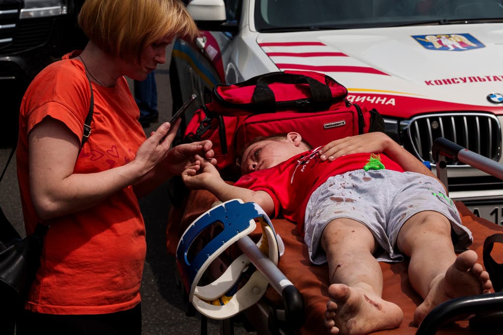 A rescuer tends to a youth at the site of Okhmatdyt children’s hospital hit by Russian missiles, in Kyiv, Ukraine, Monday, July 8, 2024. Russian missiles have killed multiple people and struck a children’s hospital in the Ukrainian capital, Kyiv, authorities say. (AP Photo/Evgeniy Maloletka)