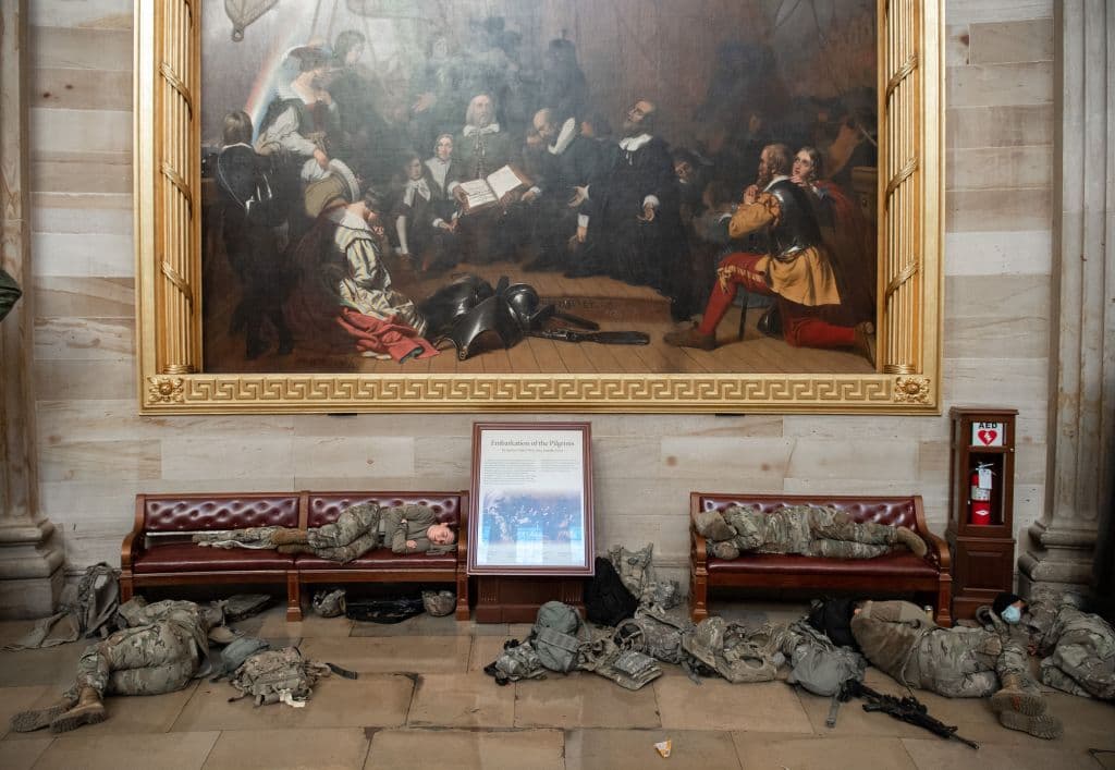 Soliders grab a break in the US Capitol, where protection was dramatically increased after a mob invaded the building on Jan 6 to try and halt the certification of election results.