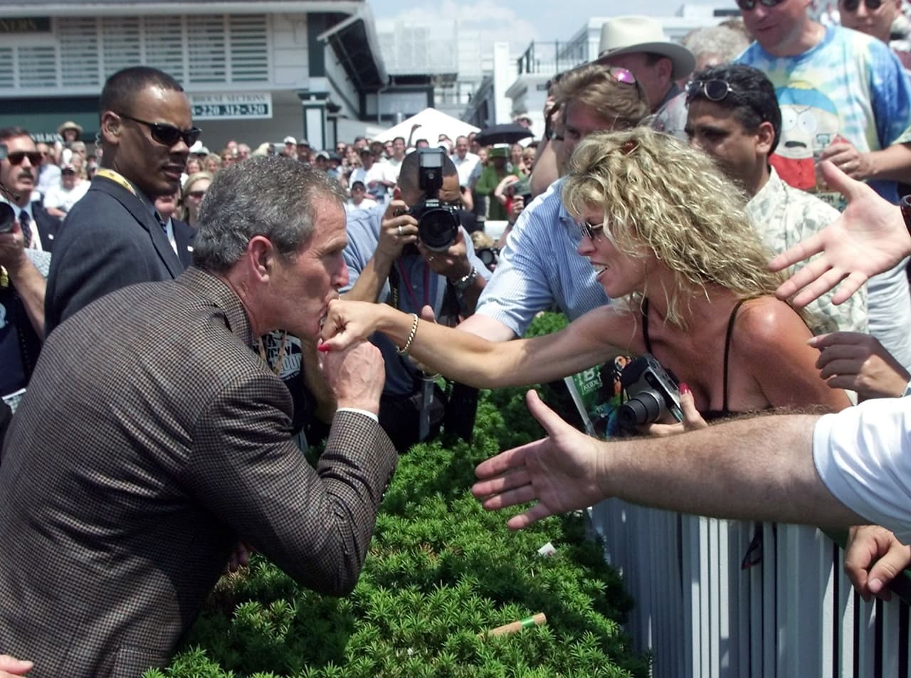 George W. Bush besa la mano de una partidaria en un viaje a Louisville, Kentucky, durante la campaña presidencial de 2000. 
<br>