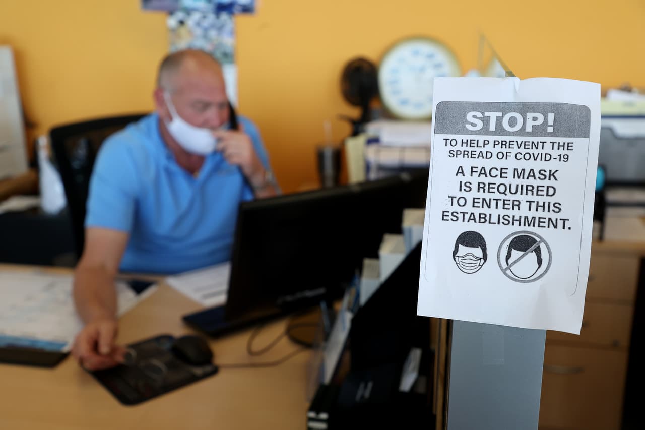 Una señal que indica que se necesita una máscara para entrar en el concesionario de coches East Hills Chevrolet en Freeport.