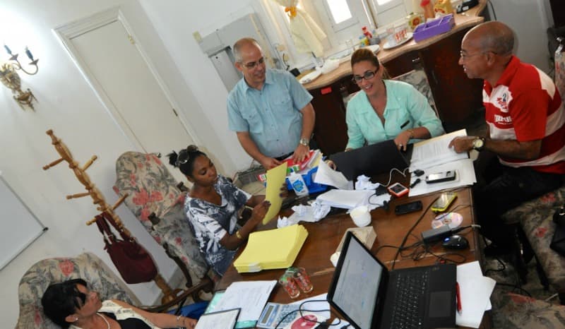 Luis Alberto Dueñas, standing, talks with partners in his accounting co-operative, Scenius, in the Miramar District in Havana. Non-farm co-operatives were first allowed in Cuba in 2013.
<br>
<br>
