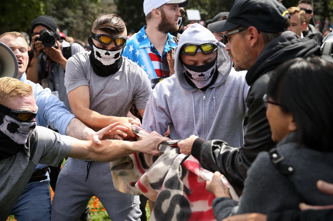 BERKELEY, CA - APRIL 15: Trump supporters clash with protesters at a "Patriots Day" free speech rally on April 15, 2017 in Berkeley, California. More than a dozen people were arrested after fistfights broke out at a park where supporters and opponents of President Trump had gathered. (Photo by Elijah Nouvelage/Getty Images)
