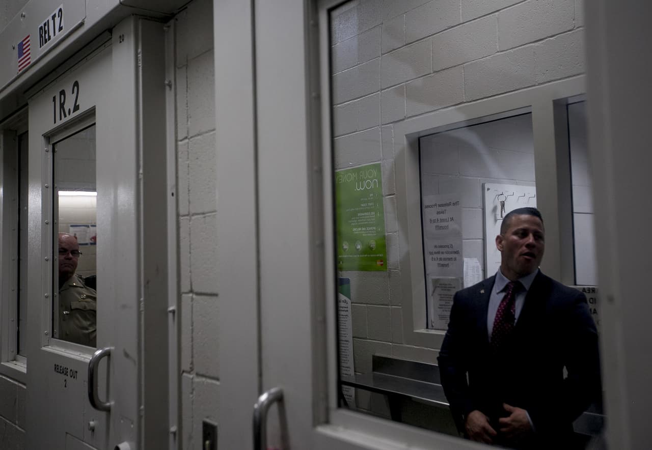 Sergeant Joaquin Enriquez's reflection is shown in the shadow of inmate looking through a window at 4th Avenue Jail in Phoenix, Ariz. on Feb. 22nd, 2017.