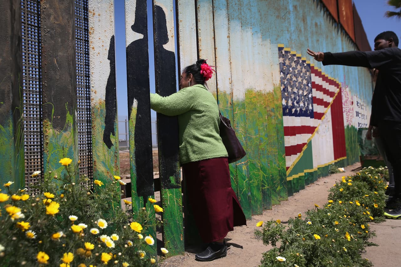 Juana Saravia Medina, 60, meets her daughter and grandchildren at the border fence May 1 2016. Her daughter emigrated to Tennessee 20 years ago. She brought her two sons to Tijuana to see their grandmother for the first time.
