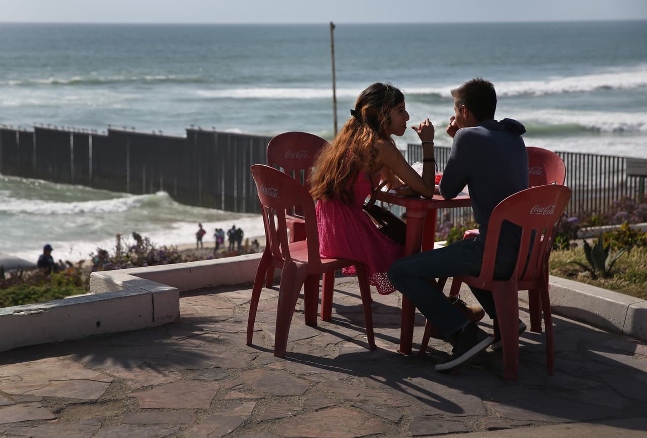 At Friendship Park some Mexicans enjoy the border scenery.