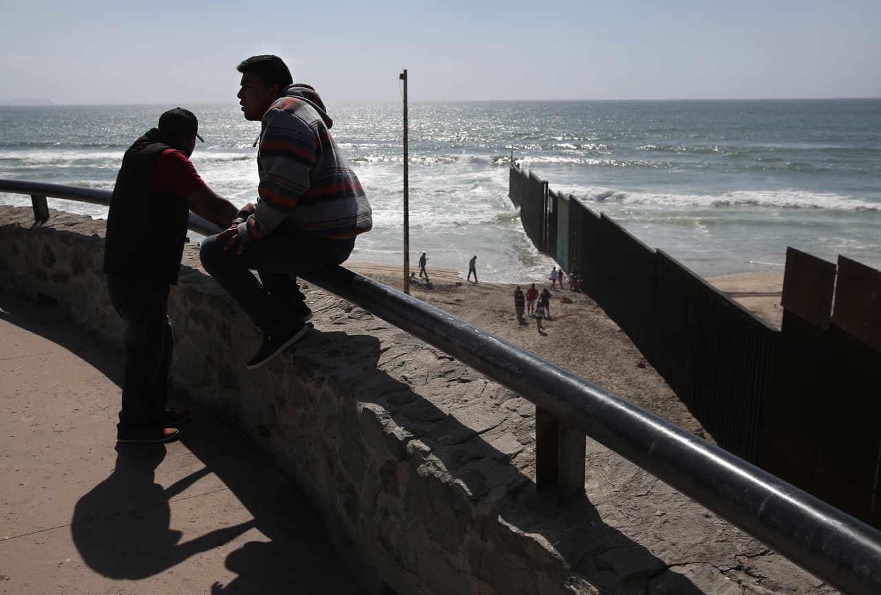 Mexicans enjoy a sprng day near the border fence that runs into the Pacific Ocean, May 1 2016, Tijuana.