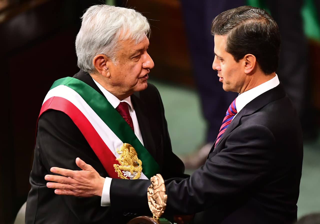 Mexico's outgoing President Enrique Pena Nieto (R) greets incoming President Andres Manuel Lopez Obrador during the inauguration ceremony, at the Congress of the Union, in Mexico City on December 1, 2018. - Lopez Obrador, 65, won Mexico's July 1 election in a landslide, and euphoric supporters are full of hope that the fiery populist will bring sweeping change, slash poverty and fight endemic corruption. (Photo by RONALDO SCHEMIDT / AFP) (Photo credit should read RONALDO SCHEMIDT/AFP/Getty Images)