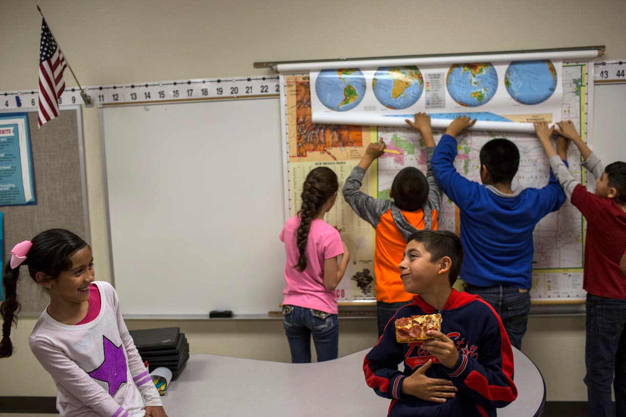 A student eats a slice of pizza during a break in a fourth grade classroom at Columbus Elementary School, in Columbus, New Mexico, Friday, March 31, 2017. American kids living in Mexico make up about 60 percent of Columbus Elementary’s student body. Many are the children of parents who were deported and moved here to be able to send their kids to school in the United States. (AP Photo/Rodrigo Abd)