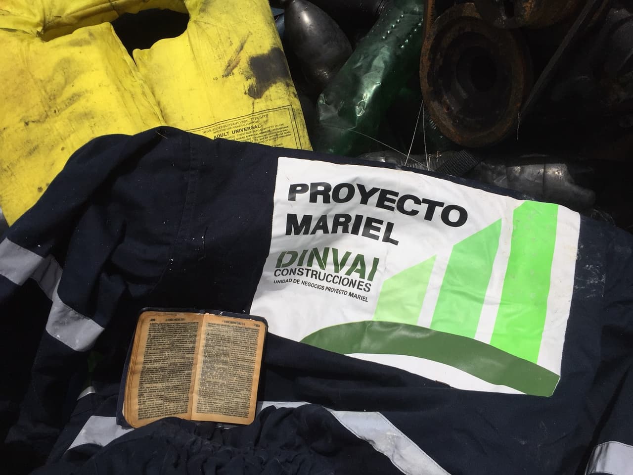 Among the contents found on an abandoned Cuban raft; a bible and the blue overalls of a worker at the Mariel port, a recently completed project on the outskirts of Havana.