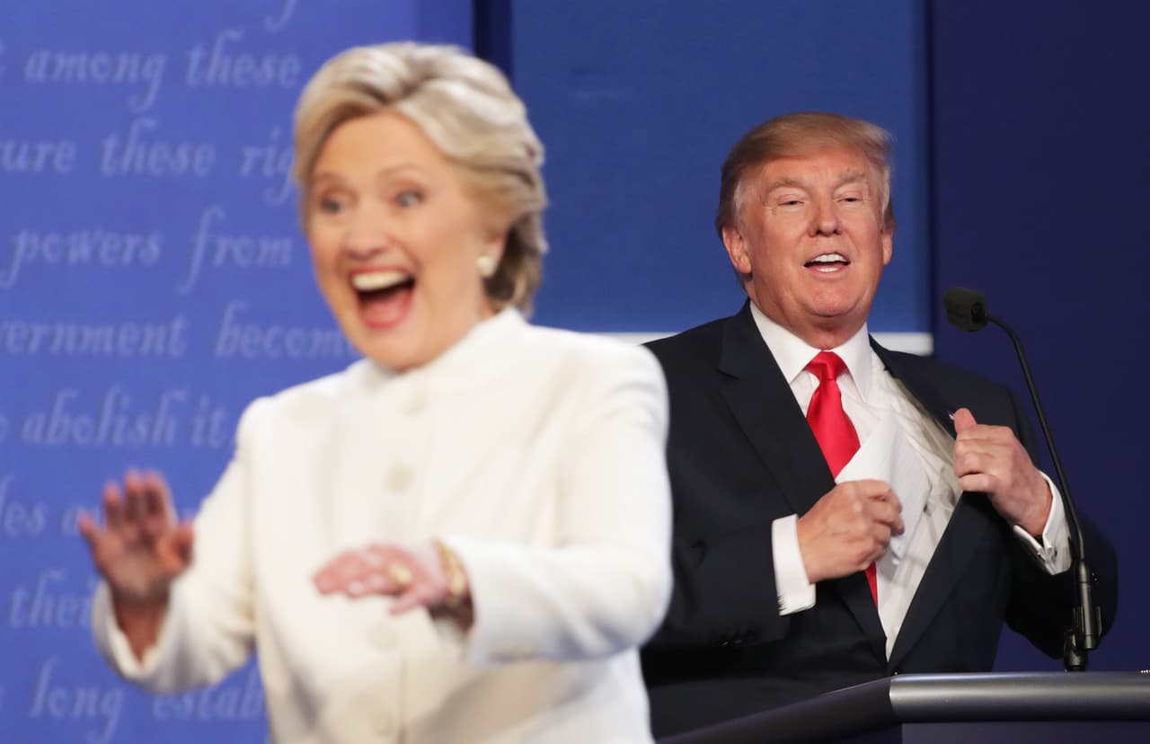 LAS VEGAS, NV - OCTOBER 19: Democratic presidential nominee former Secretary of State Hillary Clinton gestures to the crowd as she walks off stage as Republican presidential nominee Donald Trump smiles after the third U.S. presidential debate at the Thomas & Mack Center on October 19, 2016 in Las Vegas, Nevada. Tonight is the final debate ahead of Election Day on November 8. (Photo by Chip Somodevilla/Getty Images)