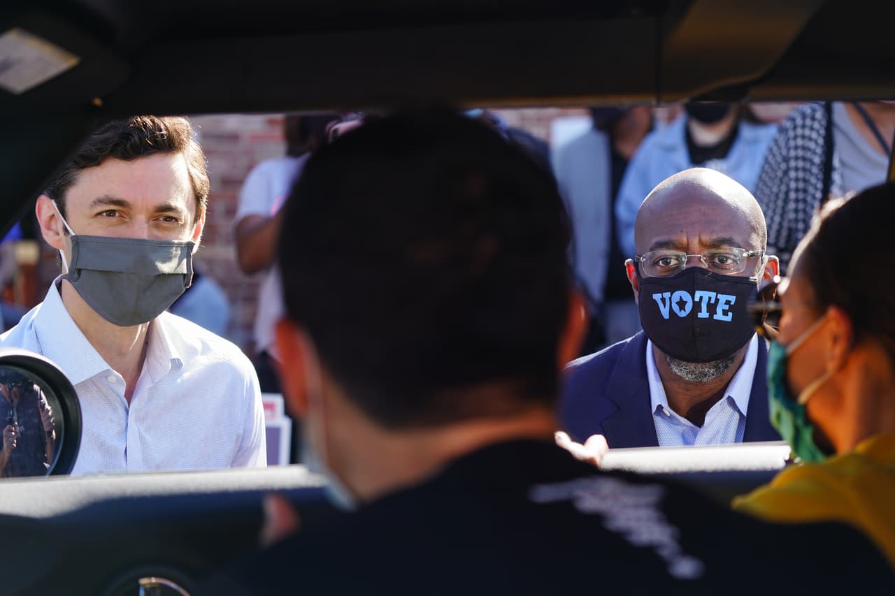 Los candidatos demócratas al
<b>Senado</b> de Estados Unidos,
<b> Jon Ossoff </b>y el reverendo
<b>Raphael Warnock</b>, hablan con simpatizantes en un automóvil en un evento de campaña en Lithonia,
<b>Georgia</b>. Los dos esperan derrocar a los senadores titulares David Perdue y Kelly Loeffler.