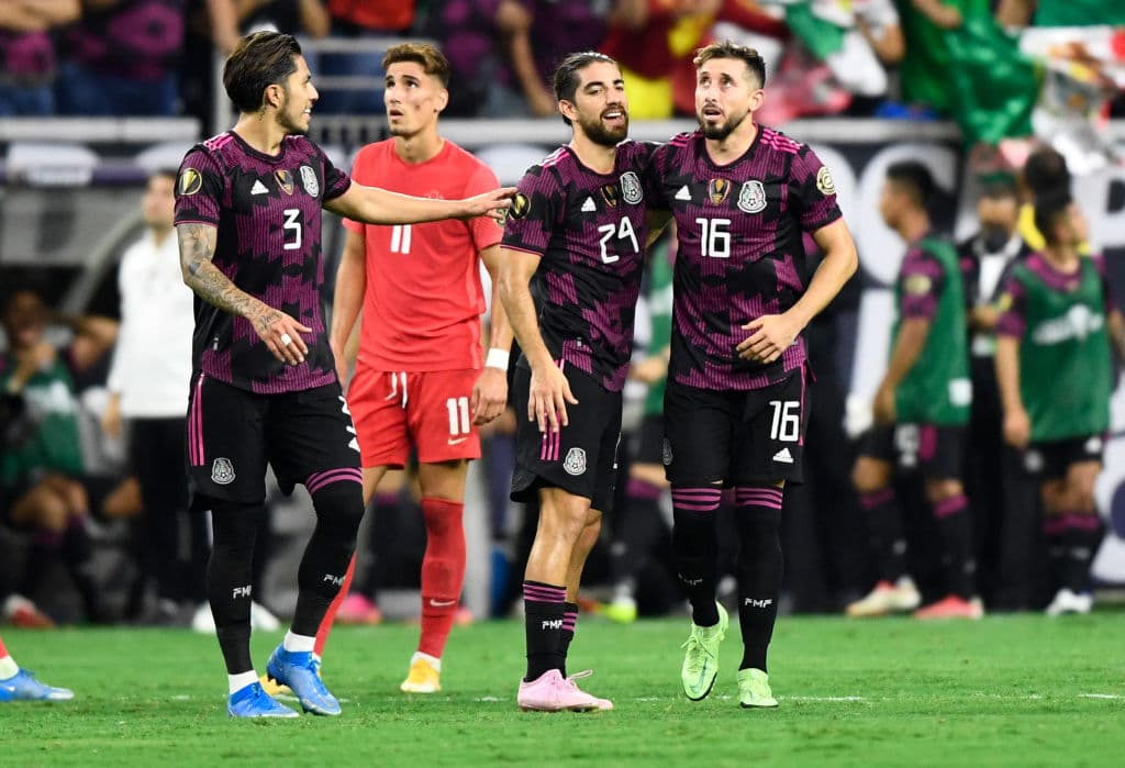 Mexico's midfielder Hector Herrera (R) celebrates scoring the winning goal with teammates during the Concacaf Gold Cup football match semifinal between Mexico and Canada at NRG stadium in Houston, Texas on July 29, 2021. (Photo by Patrick T. FALLON / AFP) (Photo by PATRICK T. FALLON/AFP via Getty Images)