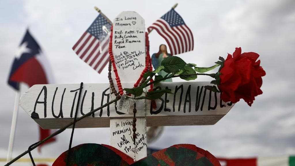 A cross honoring Arturo Benavides, 60, stands at a makeshift memorial for victims outside Walmart, near the scene of a mass shooting which left at least 22 people dead, on August 6, 2019 in El Paso, Texas.