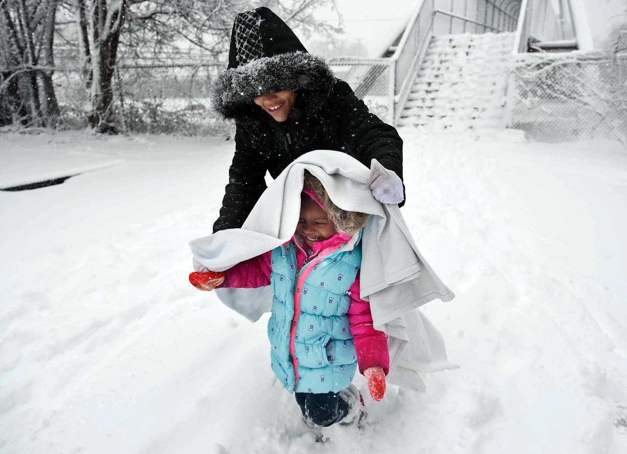 Deborah Ellison cubre a su hija, Raniya Shabazz, de 4 años, para caminar sobre la nieve en Nashville, Tennessee.