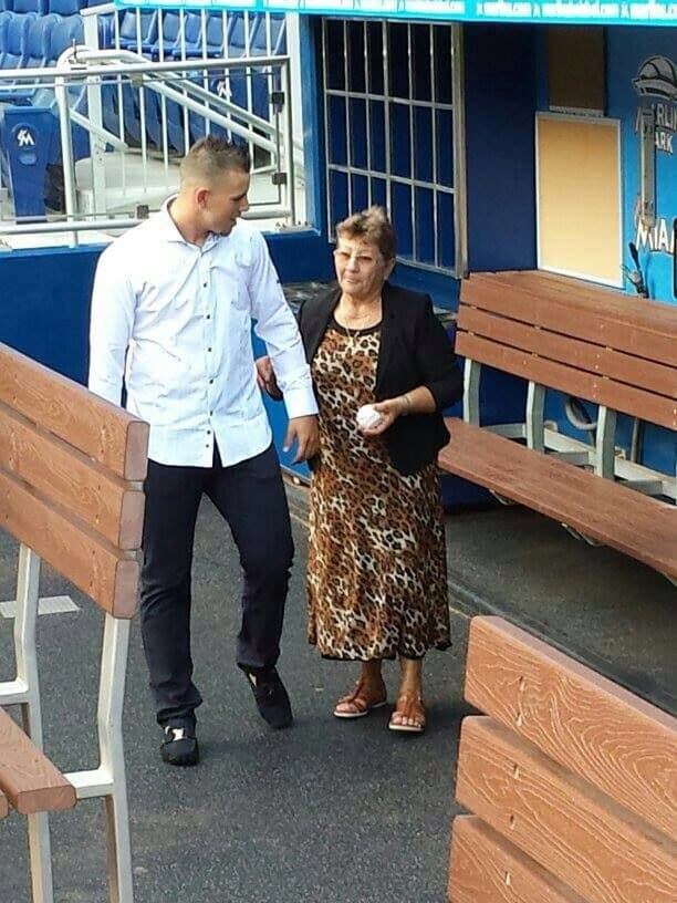 In the dugout with grandmother Olga, a passionate baseball fan who used to practice with José when he was a child. Courtesy of the Fernández family/Univision.