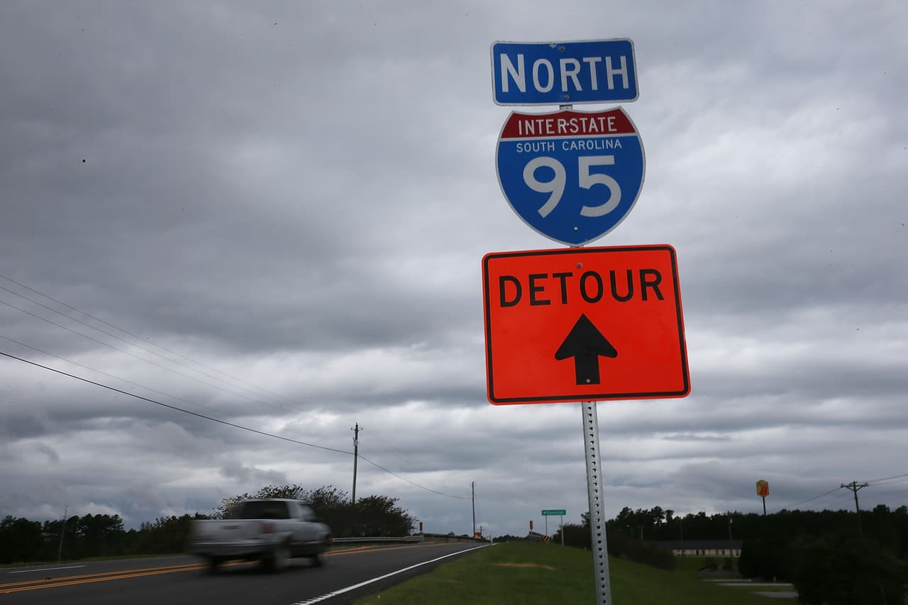 SANTEE, SC - OCTOBER 09: A detour sign helps drivers find their way around a closed I-95 as a 13 mile portion of the major east coast highway continues to be closed due to concerns about nine bridges along the closed portion of Interstate 95 that were affected by flood waters on October 10, 2015 in Santee, South Carolina. The state of South Carolina experienced record rainfall amounts and officials expect the damage from the flooding waters to be in the billions of dollars. (Photo by Joe Raedle/Getty Images)