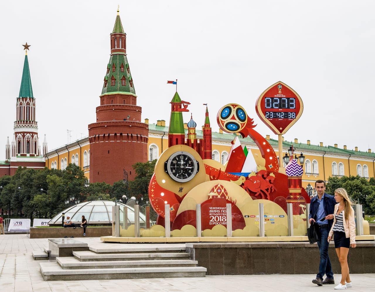 A couple walks in front of the digital FIFA World Cup 2018 countdown clock placed in front of the Red Square and the Kremlin in Moscow on September 13, 2017. FIFA announced that ticket sales for the 2018 World Cup will begin on September 14, 2017, nine months to the day ahead of the tournament's kicks off in Russia. The World Cup will be played at 12 venues in 11 Russian cities -- Moscow, Saint Petersburg, Sochi, Kazan, Saransk, Kaliningrad, Volgograd, Rostov-on-Don, Nizhny Novgorod, Yekaterinburg and Samara. / AFP PHOTO / Mladen ANTONOV (Photo credit should read MLADEN ANTONOV/AFP/Getty Images)