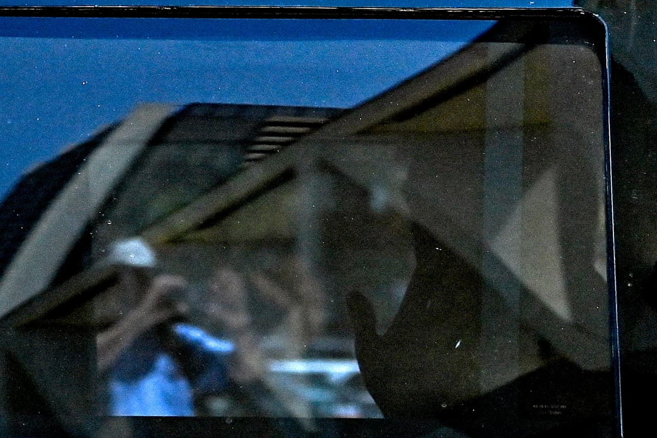 El expresidente Donald Trump fue visto a través de la ventana de su vehículo mientras llega al Palacio de Justicia Federal de los Estados Unidos Wilkie D. Ferguson Jr. en Miami. Cuatro SUVs negras entraron al garaje del tribunal, seguidas por policías.