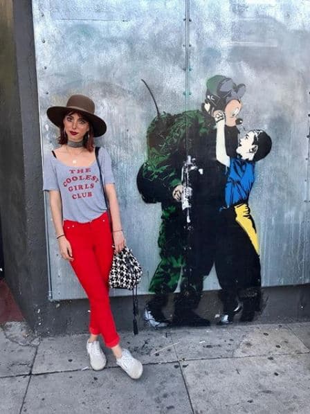 La presentadora no perdió la oportunidad de posar al lado de una de las pintas del artista callejero Banksy.