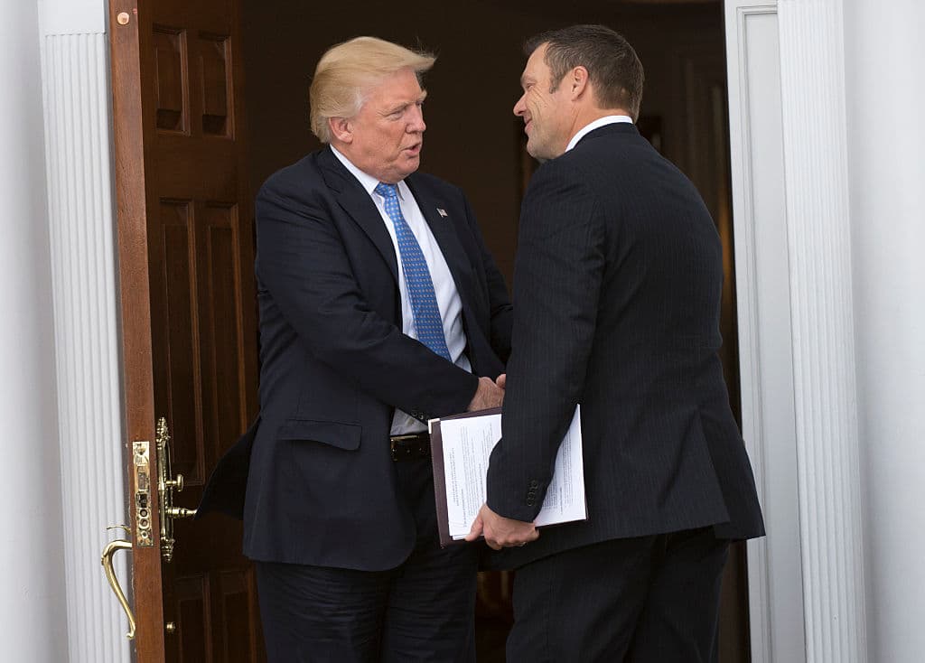 Donald Trump le estrecha la mano a Kris Kobach, vicepresidente de la Comisión de Fraude Electoral.