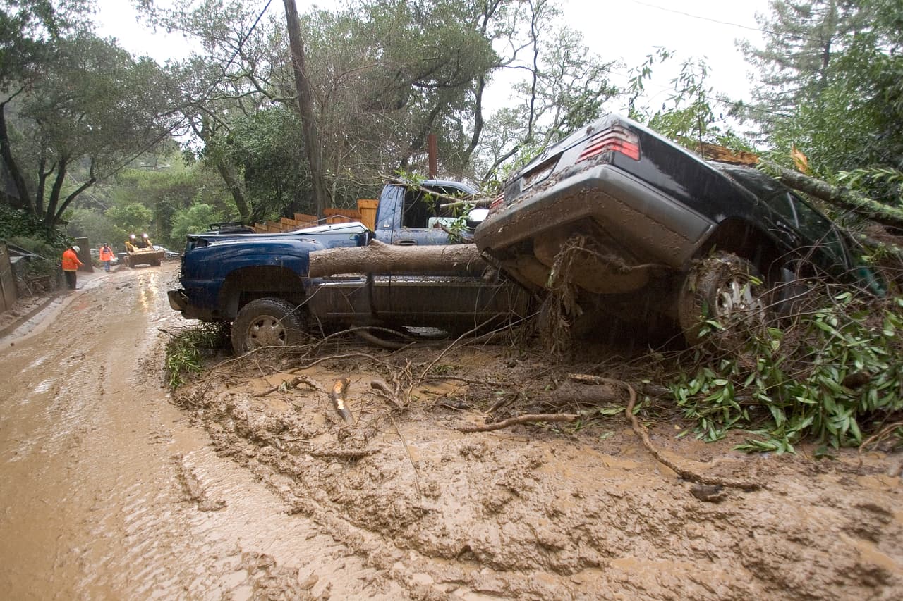FAIRFAX, CA - JANUARY 2: Cars rest where they slid off the road during a mudslide on Tamalpias Road January 2, 2006 in Fairfax, California. Northern California has been inundated by heavy rain over the past week, causing mudslides and pushing rivers over their banks. (Photo by David Paul Morris/Getty Images)